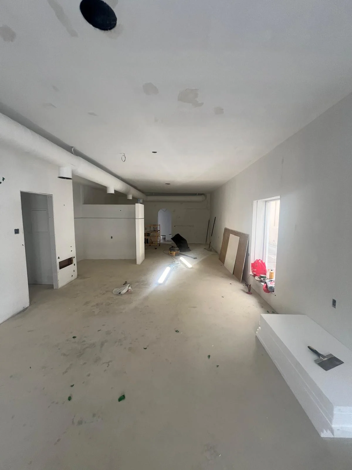 Fully finished, primed basement space ready for paint