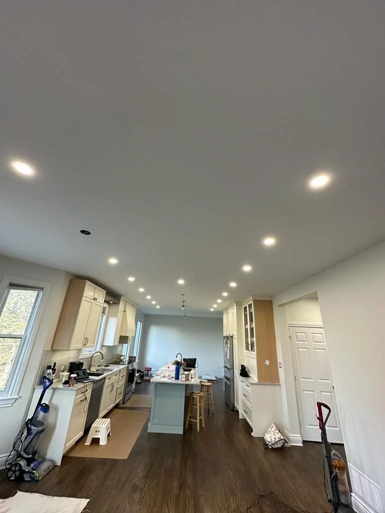 Finished kitchen ceiling with recessed pot lights and fresh paint