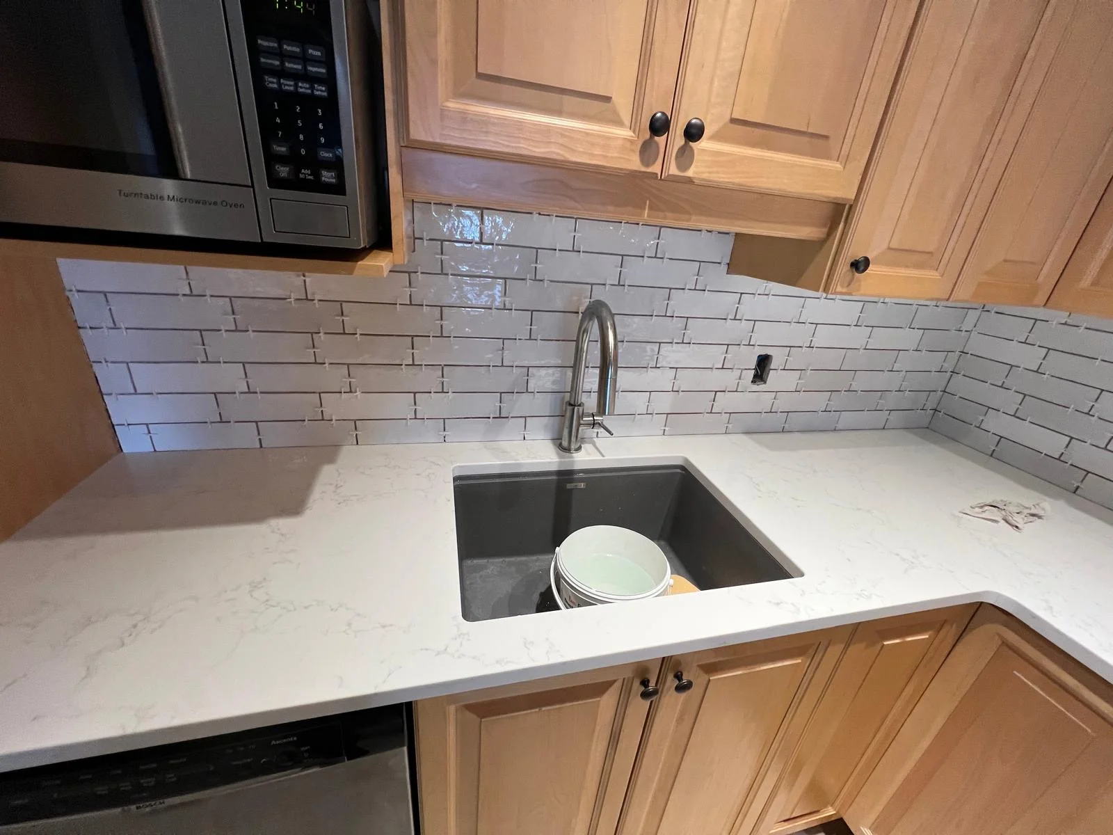 Finished kitchen backsplash tile close-up around sink